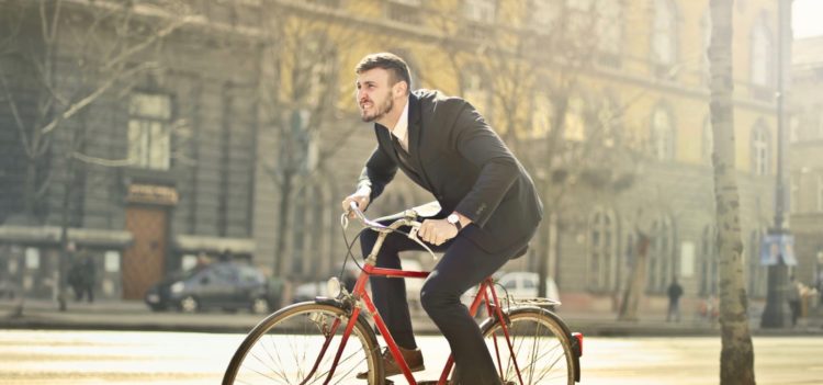 Man in a suit cycling