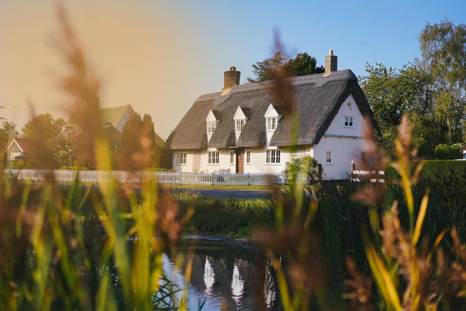 cottage with a lake at sunset